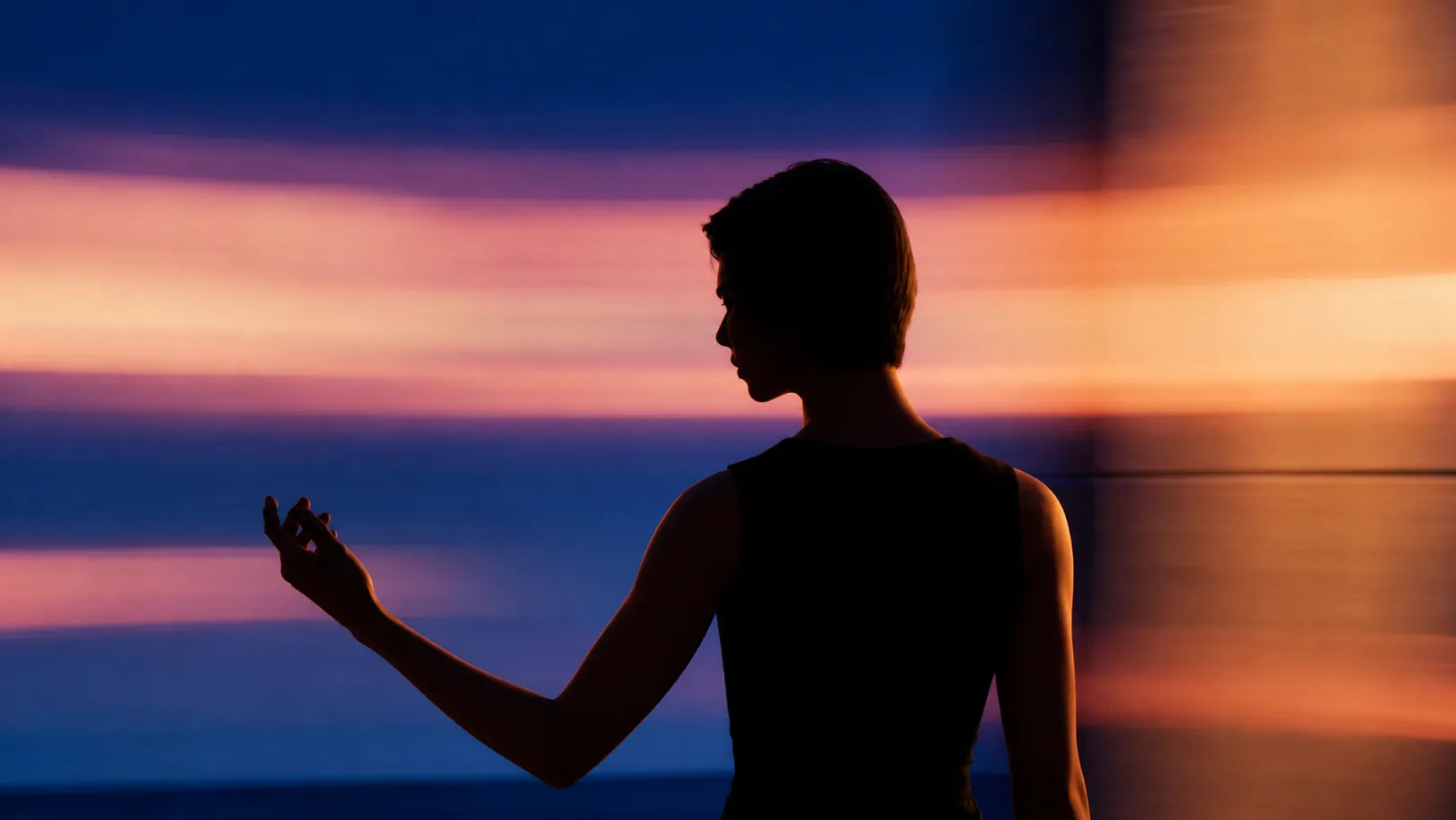 Person moving through warm L-Space lighting